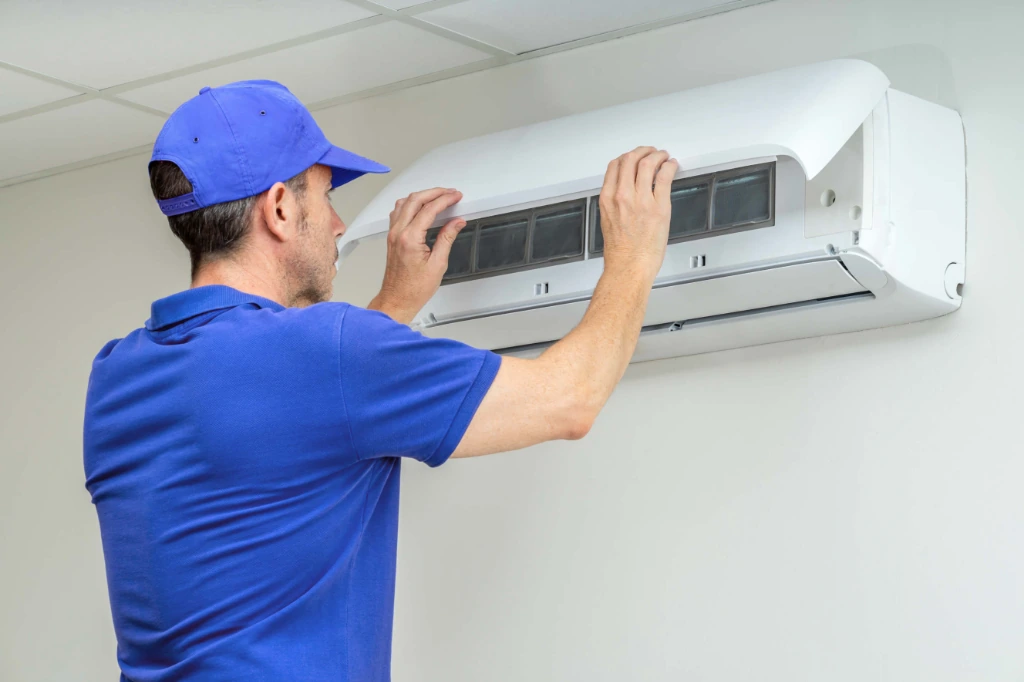 Technician checking AC electrical connections